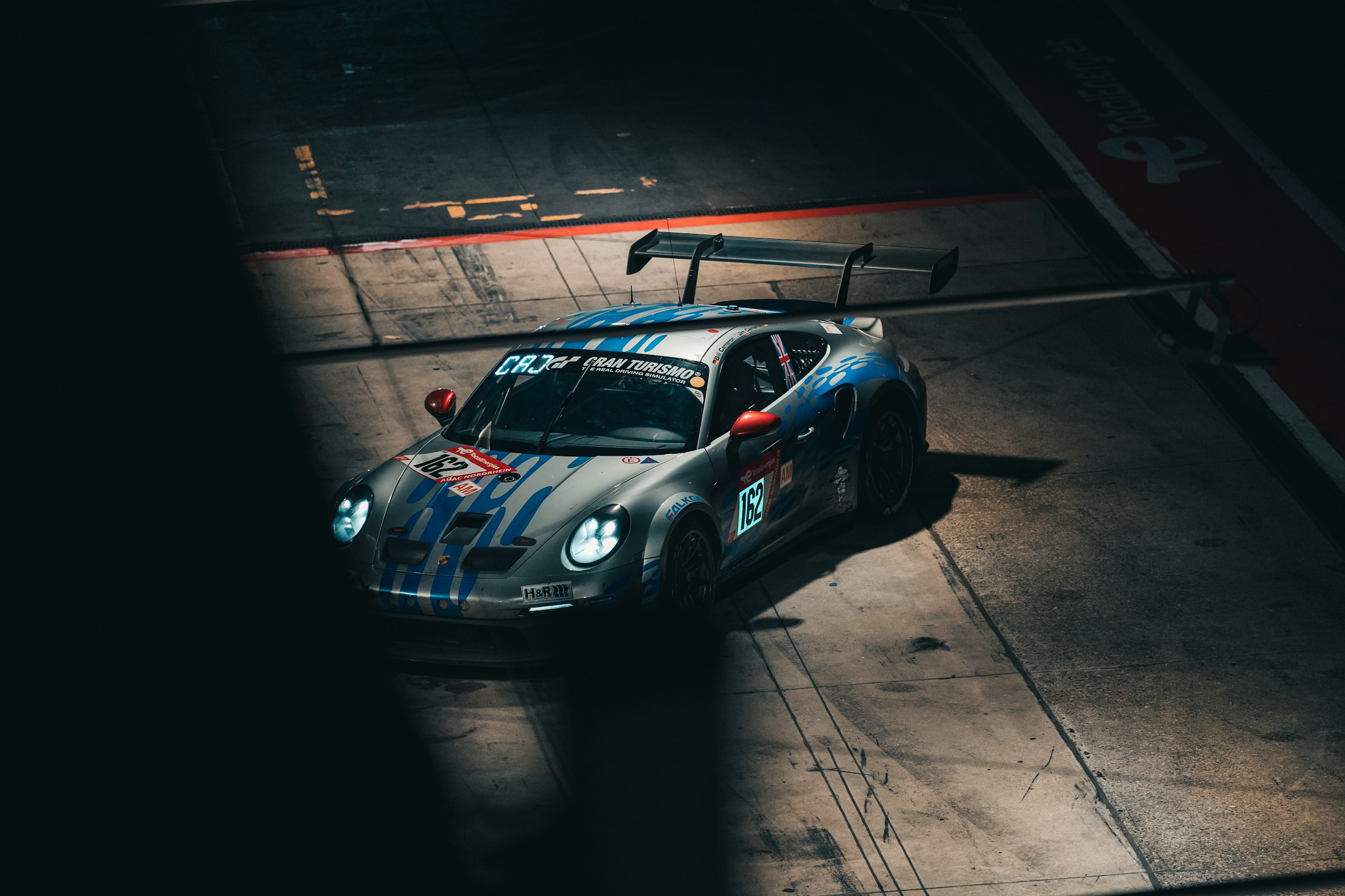 A race car on circuit in low evening light